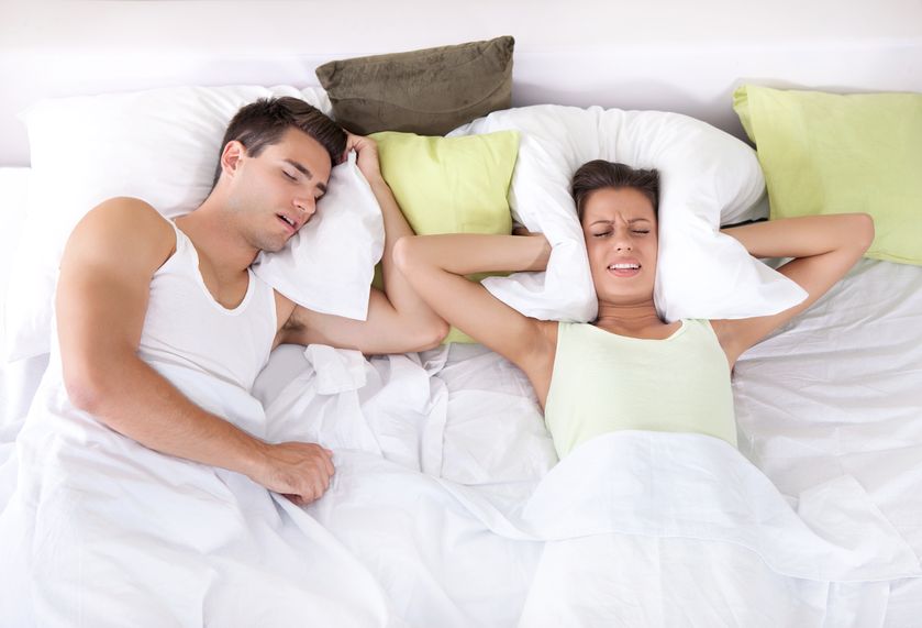 15045234_m Man snoring, woman covering ears with pillow
