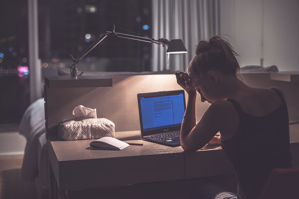 Woman feeling tired at work due to untreated sleep apnea symptoms