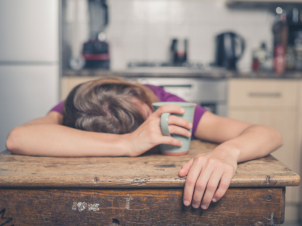 Exhausted woman asleep at a desk