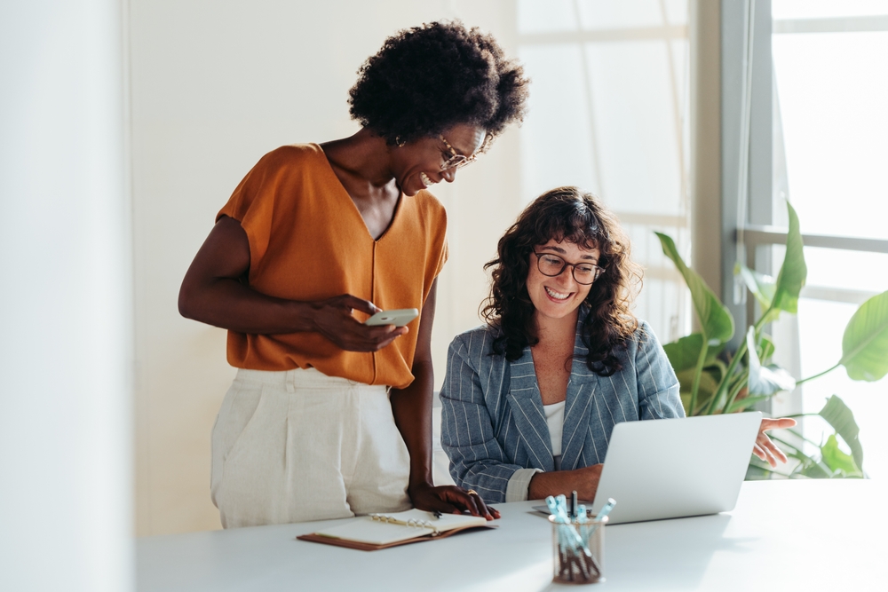 Happy,Professional,Women,Collaborating,With,Enthusiasm,In,A,Modern,Office