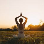 Young,Woman,Practicing,Yoga,On,Nature.,Girl,Meditating,Outdoors.,Female Woman meditating outdoors in a peaceful nature setting for better sleep